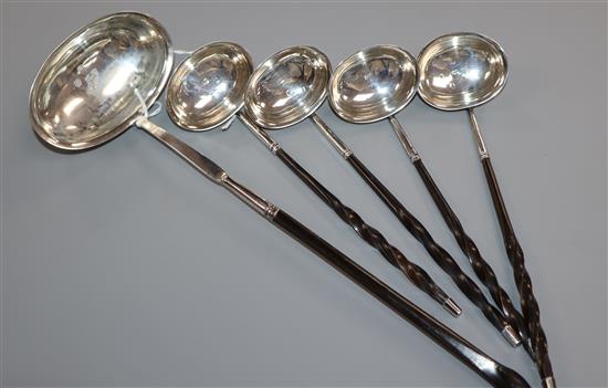 Four George III silver toddy ladles with whalebone handles and a similar punch ladle (probably a matched set),